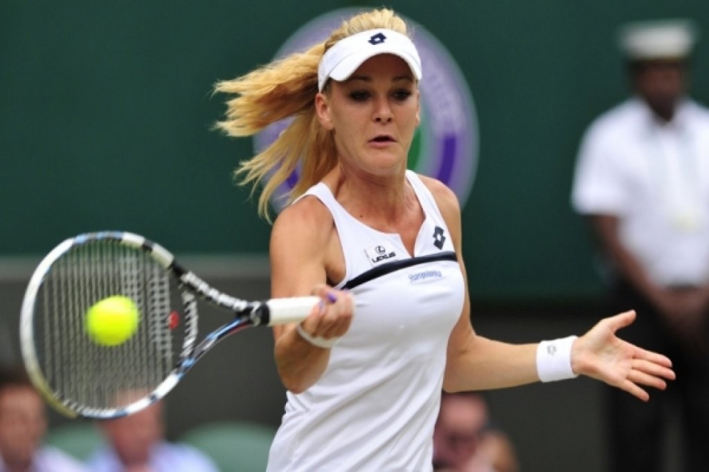 TENNIS-GBR-WIMBLEDON...Poland's Agnieszka Radwanska returns against Germany's Sabine Lisicki during their women's singles semi-final match on day ten of the 2013 Wimbledon Championships tennis tournament at the All England Club in Wimbledon, southwest London, on July 4, 2013.  AFP PHOTO / GLYN KIRK  -  RESTRICTED TO EDITORIAL USE        (Photo credit should read GLYN KIRK/AFP/Getty Images)